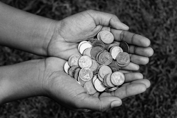 istock Close-Up Of Hand Holding Coins 1054395086