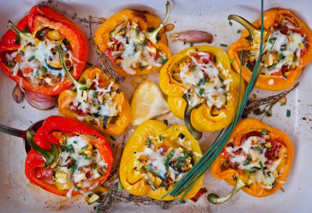STUFFED PEPPERS A SERIOUS OF COLOURED STUFFED PEPPERS stuffed pepper stock pictures, royalty-free photos & images