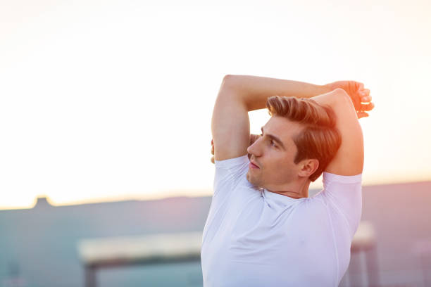 istock Young man exercising outdoors 1054400520