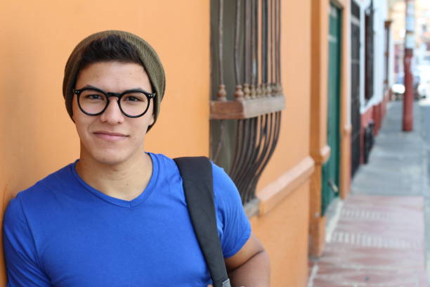 istock Handsome young hispanic male smiling outdoors 1054400854
