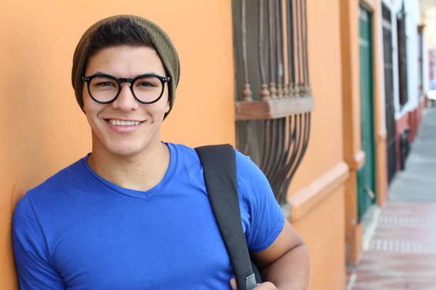 istock Handsome young hispanic male smiling outdoors 1054400856