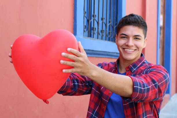 istock Young male holding a heart 1054400980