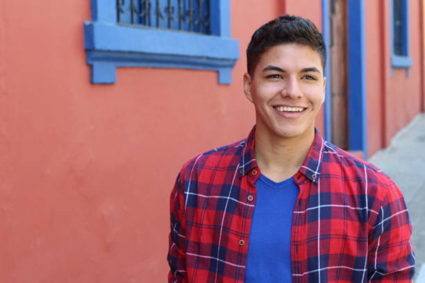 istock Handsome young hispanic male smiling outdoors 1054400994