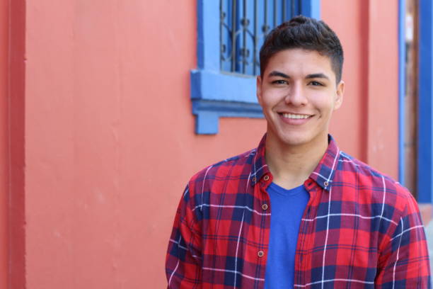 istock Handsome young hispanic male smiling outdoors 1054401006