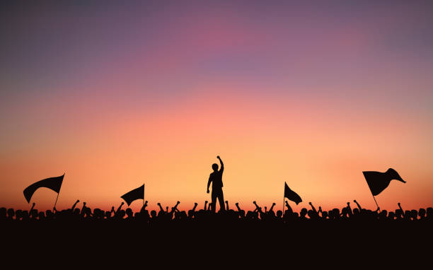 illustrations, cliparts, dessins animés et icônes de groupe de silhouette de personnes raised fist et drapeaux proteste dans la conception d��’icône plate avec fond de ciel du soir - riot