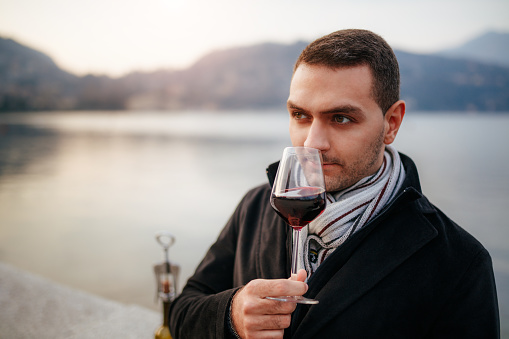 Young man tasting red wine