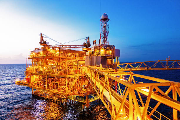 istock Offshore construction platform for production oil and gas with bridge in evening time for industrial business concept. 1054406986
