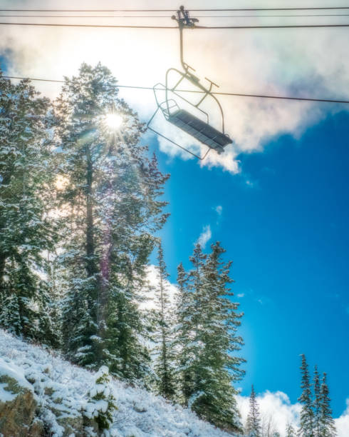A ski lift chair at Deer Valley Utah Ski Resort backlight by the sun