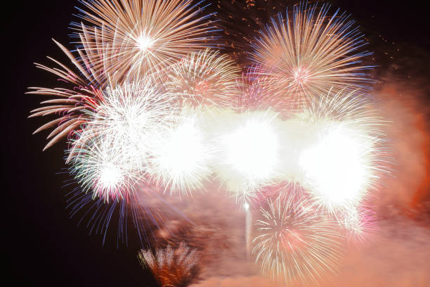 istock Festive colorful fireworks on night sky background. Celebratory holiday 1054409124