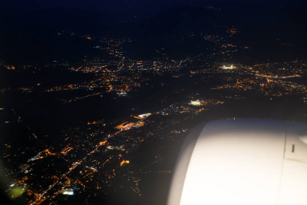 istock City view at night from the airplane porthole 1054409318