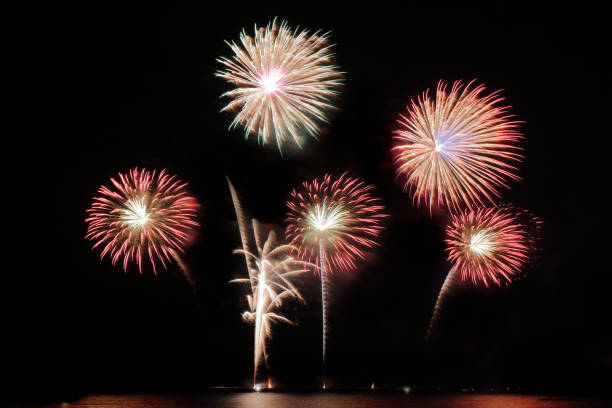 istock Festive colorful fireworks on night sky background. Celebratory holiday 1054409548
