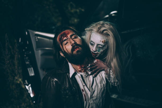 Witch attacked a man Man and woman, she masked herself in a scary witch for halloween, attacking a man. male vampire biting his victim stock pictures, royalty-free photos & images