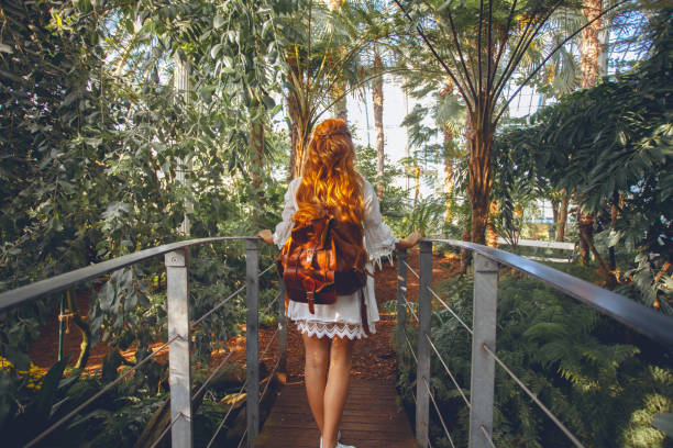 Young woman in tropical environment Young woman in tropical environment botanical garden stock pictures, royalty-free photos & images