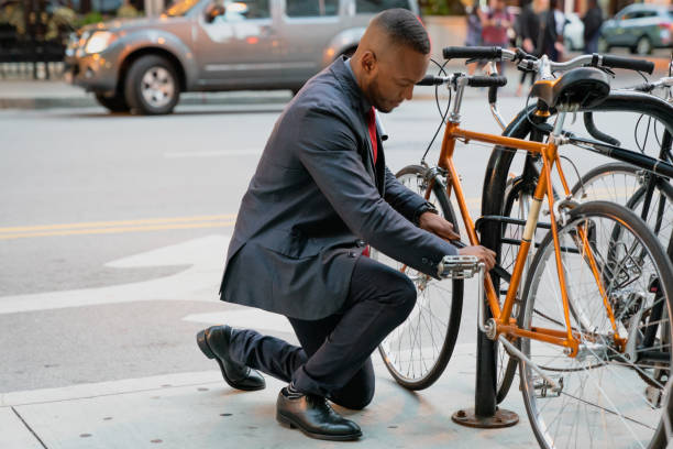 Businessman locking his bicycle in downtown Chicago