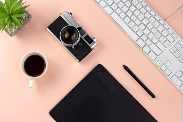istock Minimal workspace with technology equipment on pastel pink background 1054418348