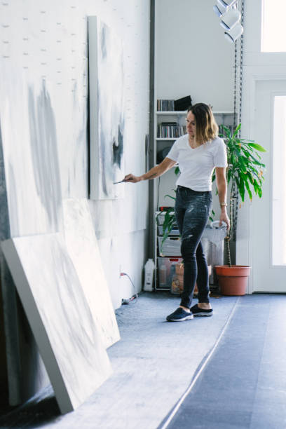 istock Woman painting canvas in art studio 1054418464