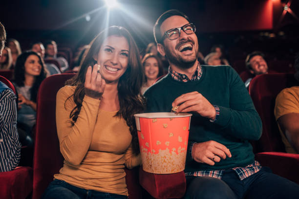 istock Smiling people with popcorn in cinema 1054418466
