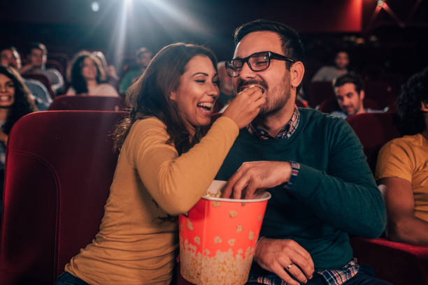 istock Woman giving her boyfriend popcorn 1054418492