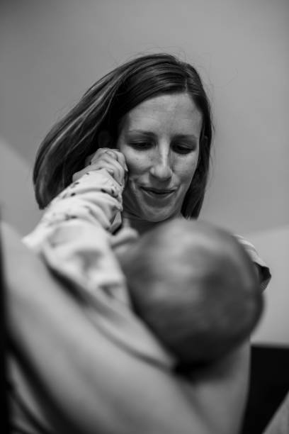istock Young mother lovingly cuddling her baby 1054418522
