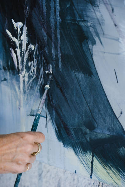 istock Woman painting canvas in art studio 1054420022