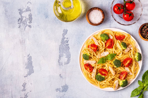 istock Plate of spaghetti tomato broccoli chicken 1054420164