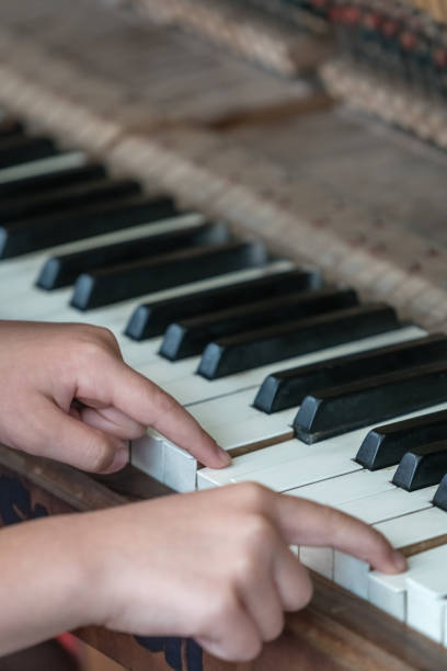 istock Little girl playing on the piano 1054422912