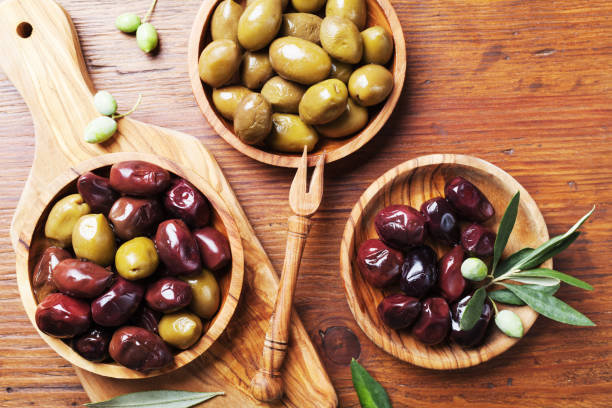 istock Natural greek olives in bowls with kitchen board from olive tree from above. 1054427568