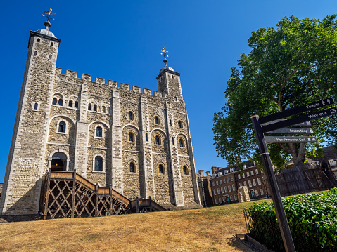 London, England - August 5, 2018: The White Tower inside the Tower of London on a warm summer day. This historic Norman Castle is England's most famous tourist attraction and a potent symbol.