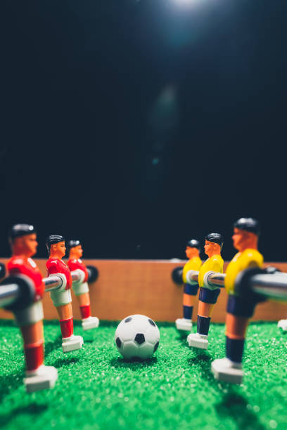 istock table football soccer kicker game players 1054429104