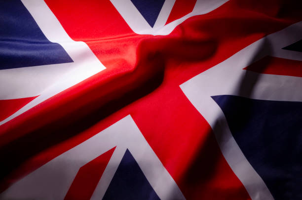 istock The Union Jack flag of Great Britain in shadow 1054429544