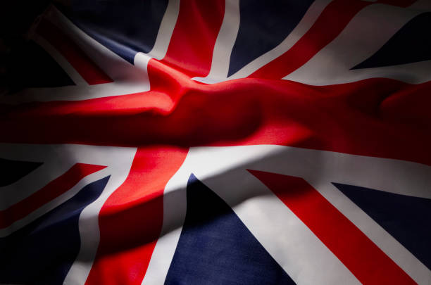 istock The Union Jack flag of Great Britain in shadow 1054429568