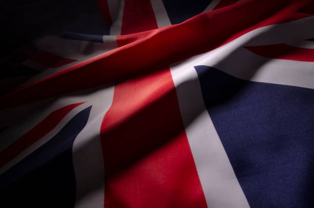 The Union Jack flag of Great Britain in shadow a close up view of Great Britain's flag in shadow and color creating a distinct design british flag photos stock pictures, royalty-free photos & images