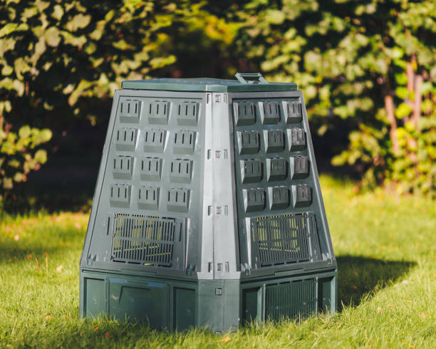 istock compost bin on green grass and foliage background 1054435584