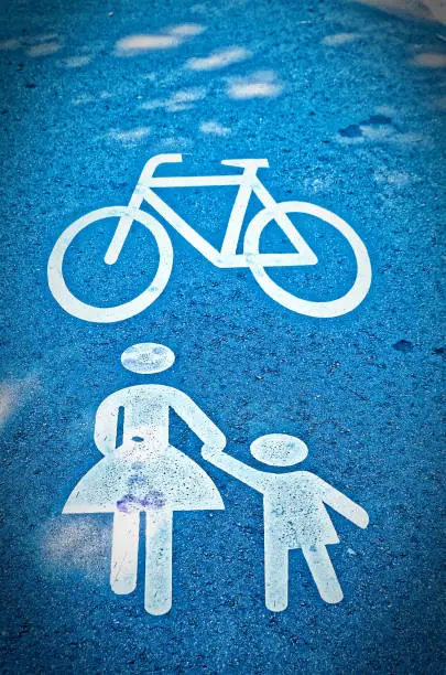 Traffic sign on a bike path. Pedestrian or woman with child to illustrate a pedestrian path