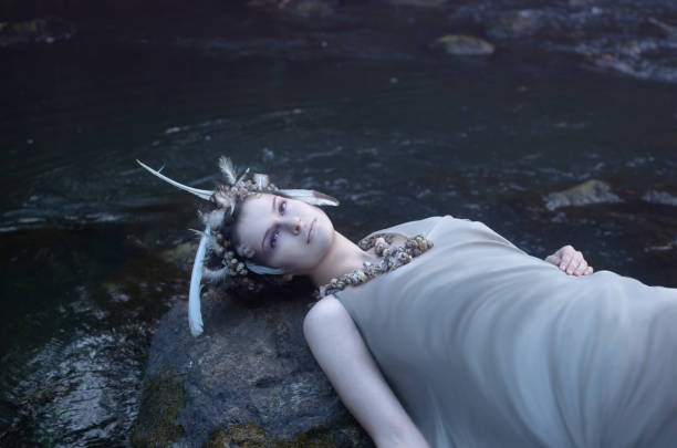 istock mermaid resting on a rock in the water 1054437022
