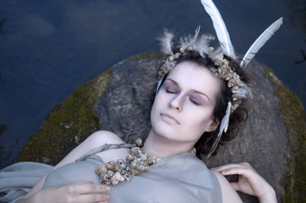 istock mermaid resting on a rock in the water 1054437216