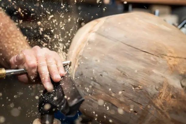 piece of timber rotates to create wooden bowl with turnery machine