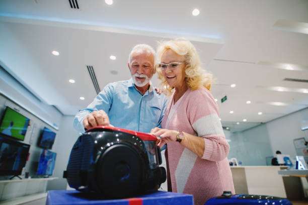 istock Beautiful senior at tech store. Looking for a new vacuum cleaner. 1054439958