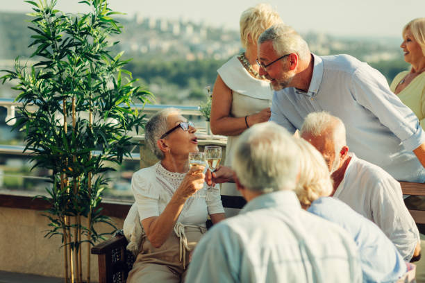istock Senior Friends On Rooftop Party 1054443910