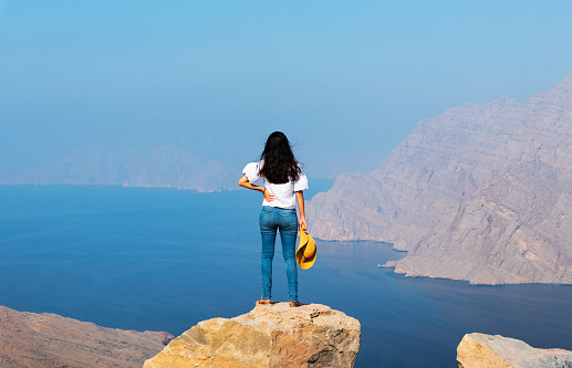 Woman enjoying view over Fjord Khor Najd in Musandam Oman