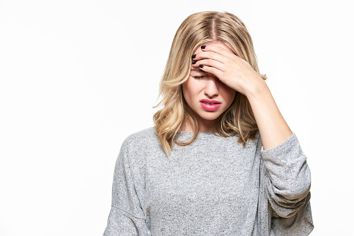 Young Woman Having Headache. Stressed Exhausted Young Woman Having Strong Tension Headache. Waist up Portrait Of Beautiful Woman Suffering From Migraine, Feeling Pressure And Stress.