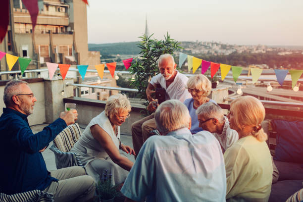 istock Senior Friends On Rooftop Party 1054444696
