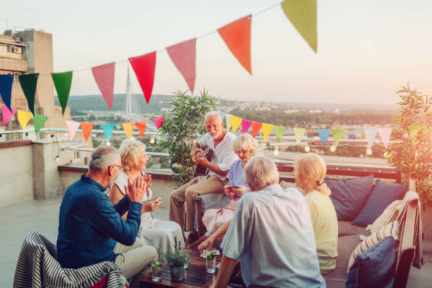 istock Senior Friends On Rooftop Party 1054446858