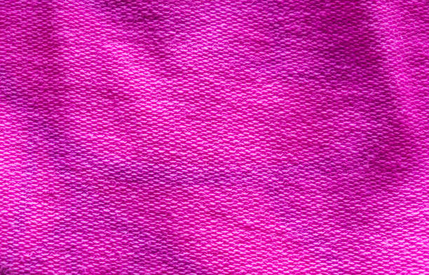 istock Deep vibrant pink colored cotton cloth fabric macro close up background 1054447018