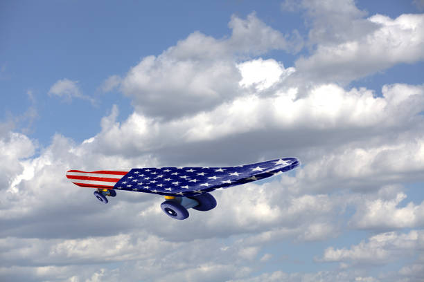istock Flying Skateboard with USA flag on a blue sky and clouds 1054447088