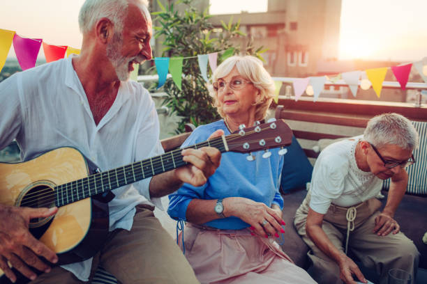 istock Senior Friends On Rooftop Party 1054447226