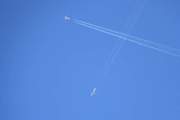 istock Crossing Airplanes at the blue sky 1054449322