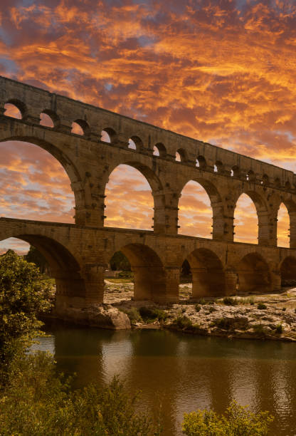 Sunset over The Pont du Gard. Pont du Gard (Gard Bridge)  is a famous ancient Roman aqueduct that crosses the Gardon River in southern France
