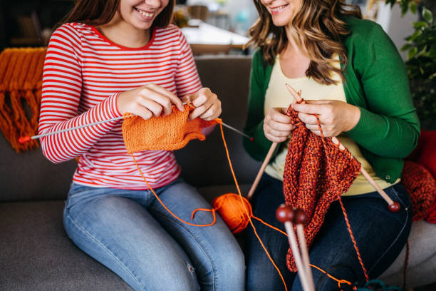 Together knitting Photo of mother with her daughter knitting at home knitting photos stock pictures, royalty-free photos & images