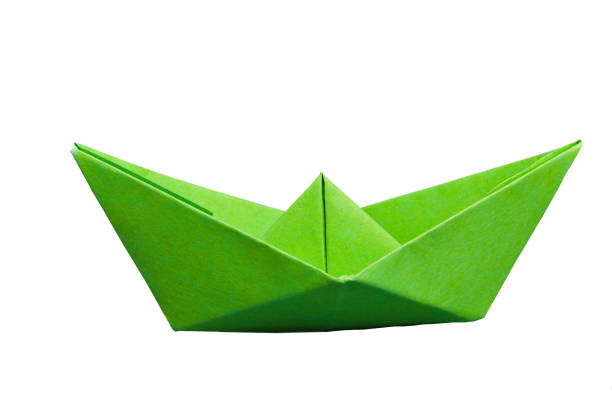 istock Isolated green paper boat on white background 1054456040